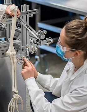 Engineering student working on skeleton arm