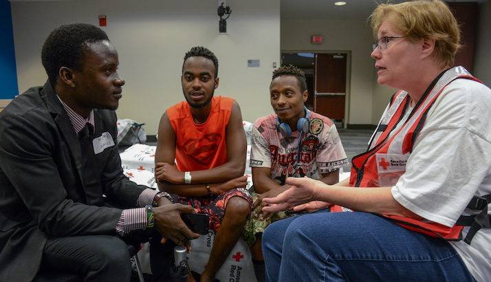 Red Cross Mental Health Volunteer Helping Young Men