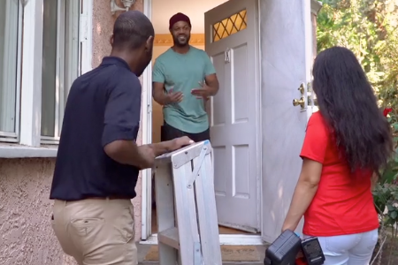 Red Cross volunteers greet a homeowner using American Sign Language