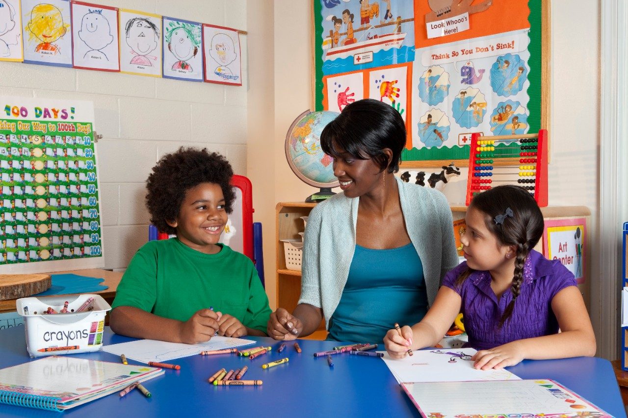 woman and students in classroom