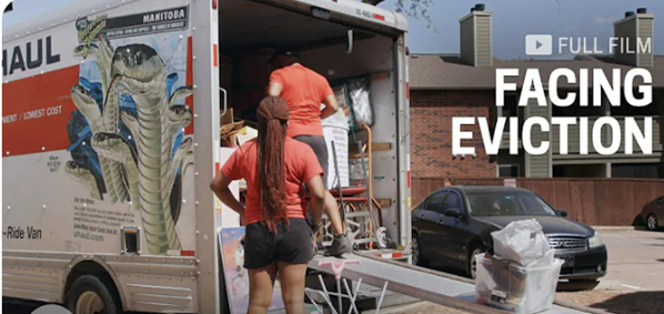 Two women loading a moving van.