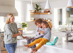 Family cleaning kitchen counter.