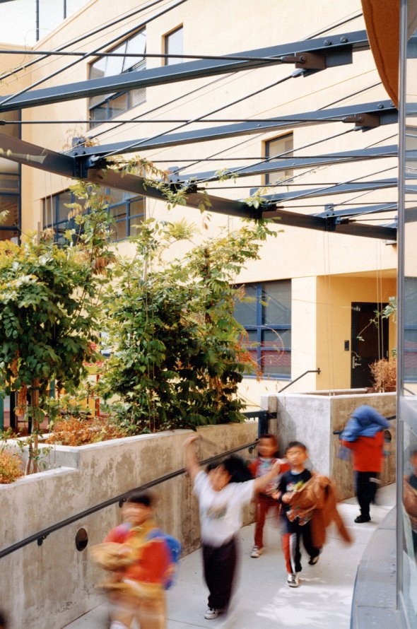 Students running down courtyard path