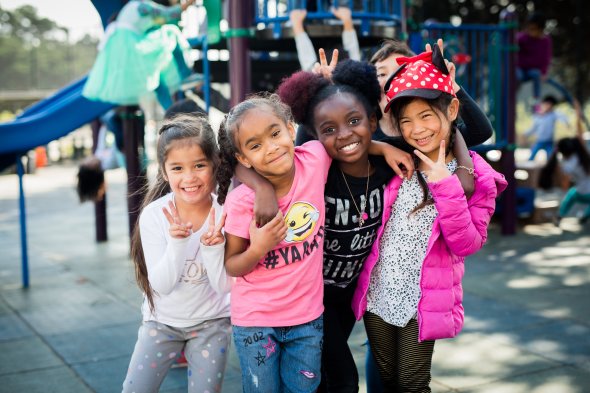 4 girls smiling at the camera