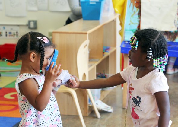 Girls playing with doll