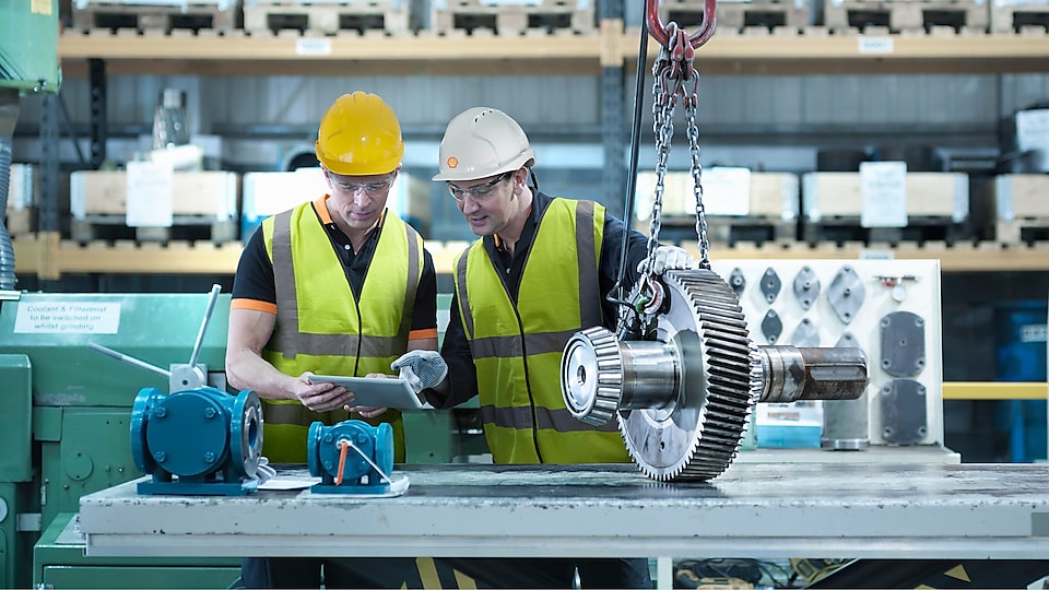 Shell worker consulting an industry worker on site