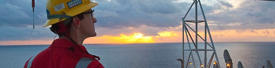 Engineer on the heli-deck at sunset on a deep-water platform in the Gulf of Mexico