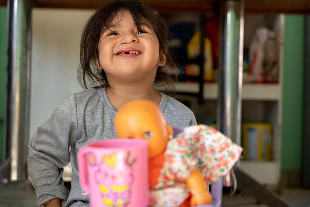 Isabella plays with her toys