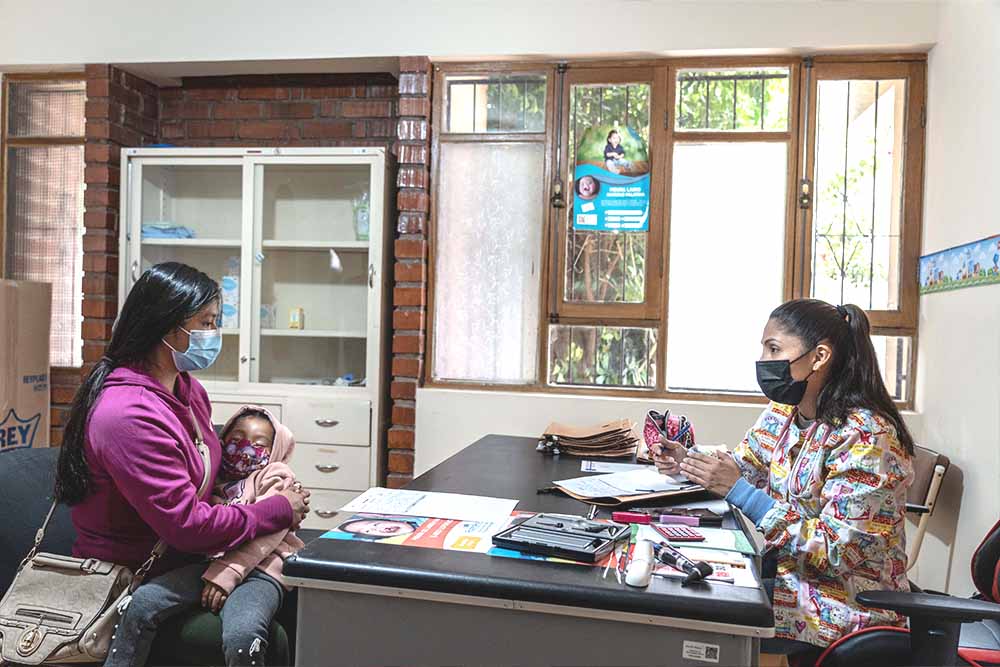 Staff meets with a family member and young patient