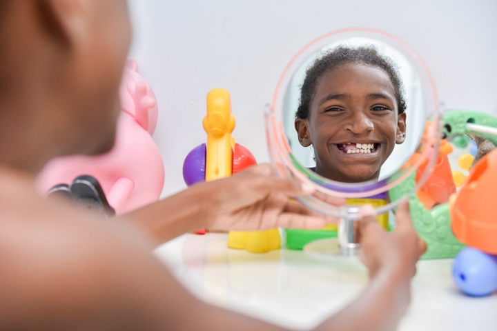 Girl looks at herself in mirror