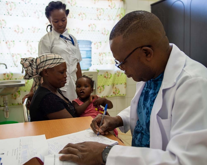 child with a cleft receiving a checkup