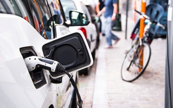 Detail of the plug of an electric car being charged
