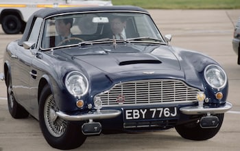 The then Prince of Wales driving his Aston Martin DB6 Volante at Heathrow Airport in 1993