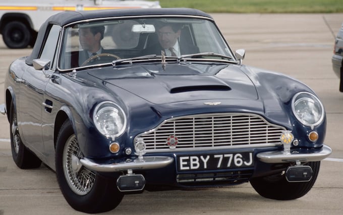 The then Prince of Wales driving his Aston Martin DB6 Volante at Heathrow Airport in 1993