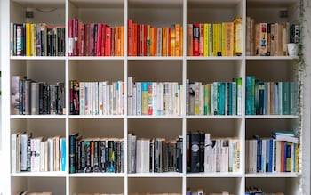 White wooden bookcase filled with books in a UK home setting