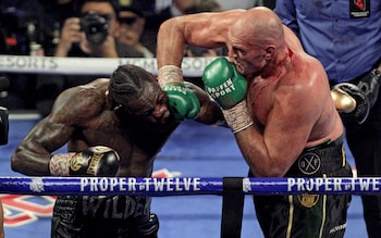 British boxer Tyson Fury (R) slams a right to the head of US boxer Deontay Wilder during their World Boxing Council (WBC) Heavyweight Championship Title boxing match at the MGM Grand Garden Arena in Las Vegas