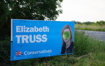 A lettuce covers a Liz Truss campaign poster