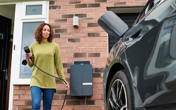 charging electric car on driveway