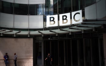 People stand outside the Broadcasting House, the headquarters of the BBC