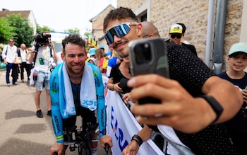 Mark Cavendish poses for a photo after the time trial