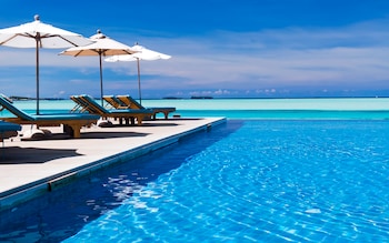 Loungers and umbrellas on a deck next to the sea