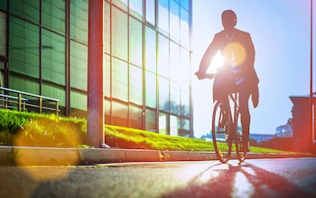 man cycling in sunshine