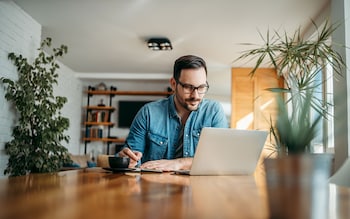 man working on laptop at home