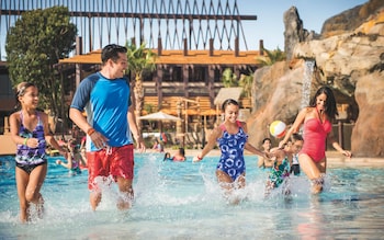 Parents and their children walking out of a water park pool 