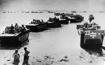 US troops disembark from landing crafts during D-Day
