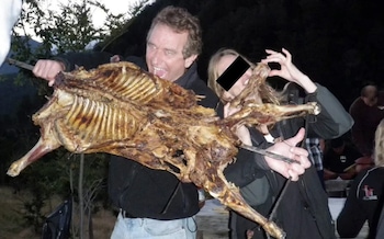 The photograph shows Robert F Kennedy pretending to take a bite out of the carcass