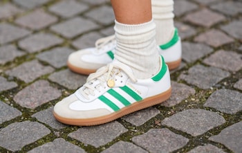 Image shows green-on-white adidas sneakers