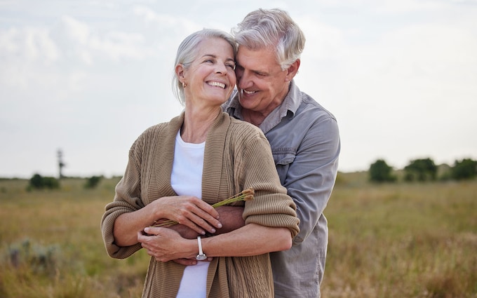 Happy couple in the garden discussing what is an equity release mortgage