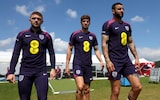 Kieran Trippier, John Stones and Kyle Walker of England walk to a training session at Spa & Golf Resort Weimarer Land on June 23, 2024 in Blankenhain, Germany