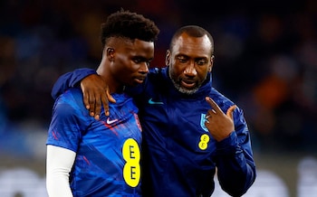 England coach Jimmy Floyd Hasselbaink speaks with Bukayo Saka before their Euro 2024 qualifier in Naples