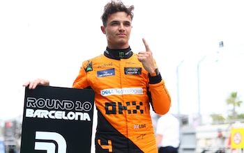 Lando Norris celebrates taking pole position