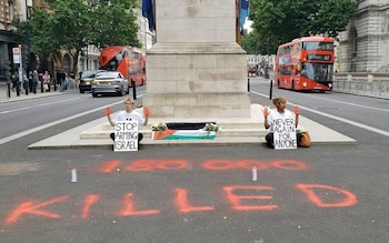 Two protesters have laid flowers and a Palestinian flag at the cenotaph