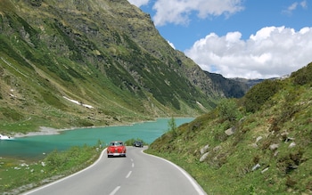 A car is driven along an Alpine road