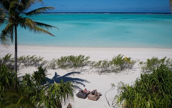 two people on white sand beach