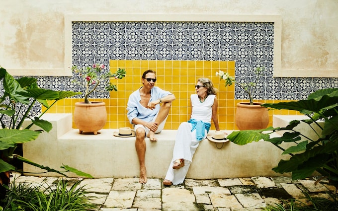 senior couple relaxing in courtyard at tropical resort