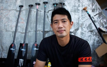 Wang Naiyi with a row of dragon boat oars