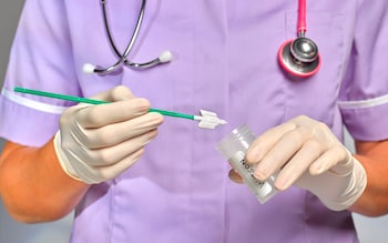 Medical practitioner conducts a smear test