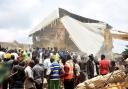 People and rescuers gather at the scene of a collapsed two-storey building in Jos, Nigeria (AP)