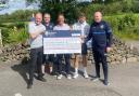 Tony Fitzpatrick, centre, presents a cheque alongside other tournament organisers