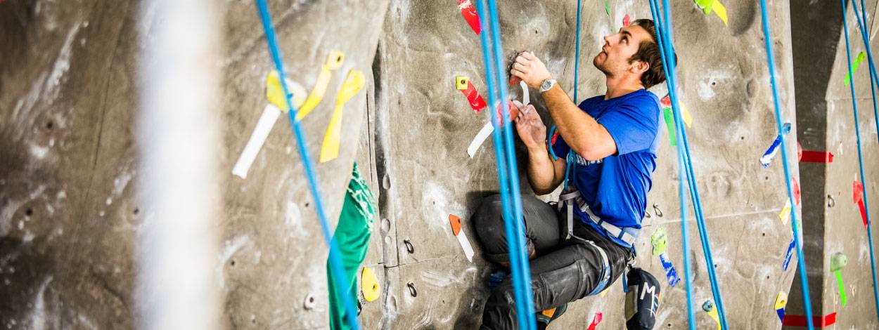 Student using the rock climbing wall at the UAF Student Recreation Center