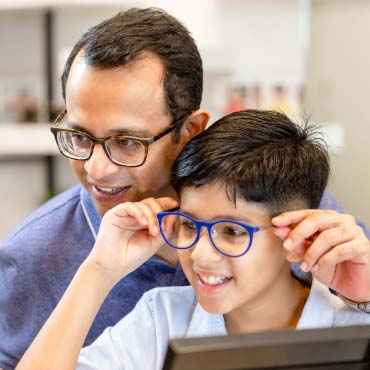 A parent and child wearing glasses