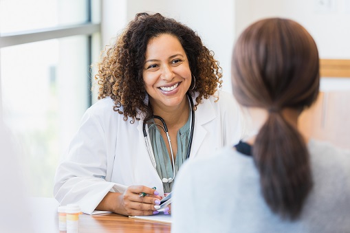 Friendly doctor listens to female patient