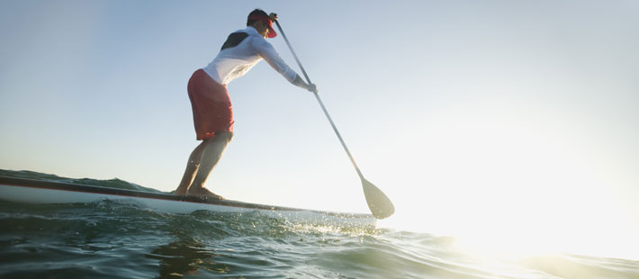 orthopaedic surgery orthopaedic surgeon man paddleboarding into sun