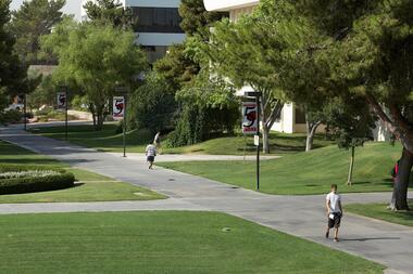 Students walk along large sidewalk