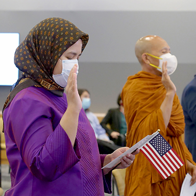 People taking the Oath of Allegiance to become citizens at USCIS headquarters