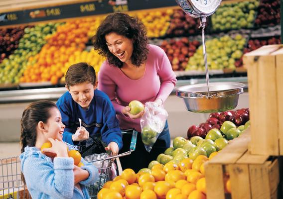 Children shop with a parent in a grocery store